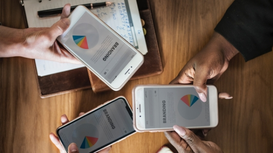 Three iphones with displayed charts